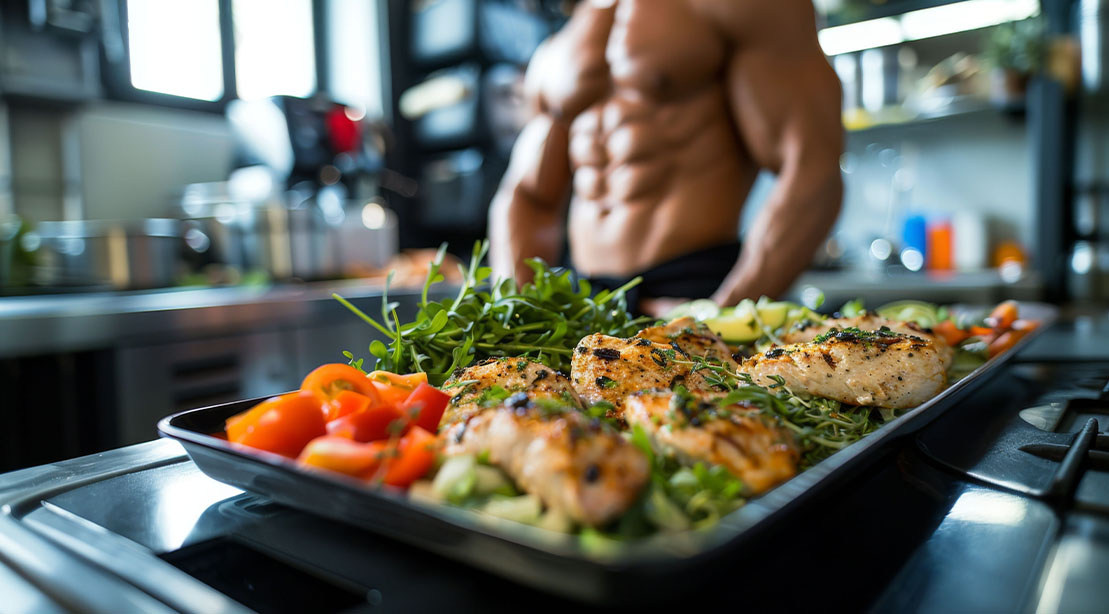 A healthy plate of grilled chicken and salad for a bodybuilder clean meal plan during his bulking cycle