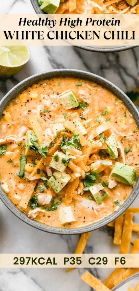 Bowl of white chicken chili topped with cilantro and avocado