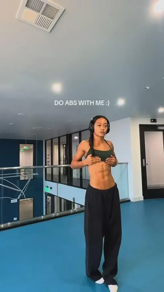 Olivia Jewel demonstrating an abs workout routine with planks and reps for a toned core.